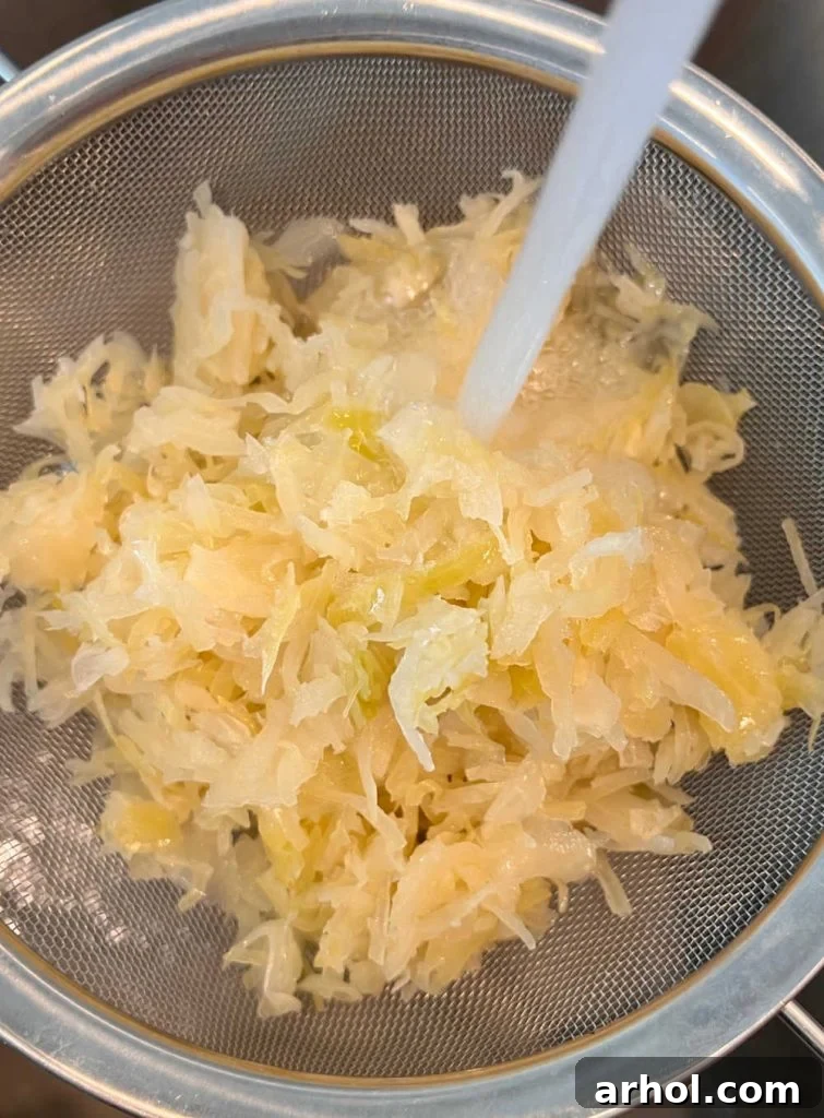 Rinse sauerkraut in mesh strainer