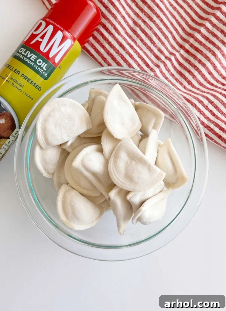 olive oil spray and Mrs T's frozen pierogies in a bowl
