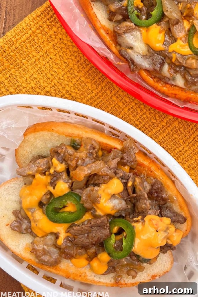 A close-up view of Arizona Blackstone cheesesteaks on a table, highlighting the rich filling and vibrant toppings.