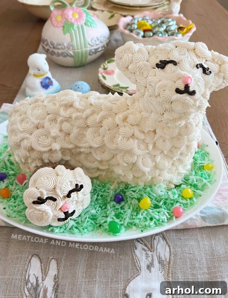 Irresistible Easter Lamb Cake 8 Decorated Easter Lamb Cake with a matching lamb cupcake, surrounded by colorful jelly beans and green coconut grass on a festive Easter table
