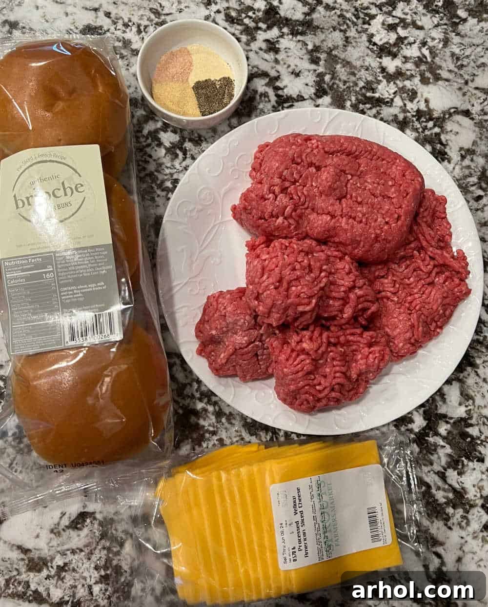ground beef, sea salt, black pepper, garlic powder, onion powder, avocado oil, butter, American cheese slices, and burger buns laid out for smash burgers.