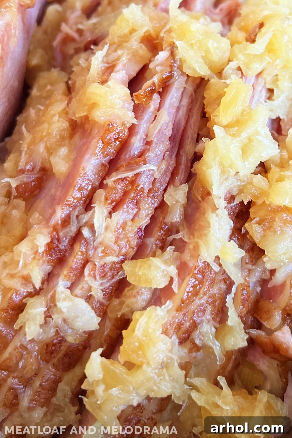 Close up view of a tender, juicy slow cooker ham with caramelized pineapple and brown sugar glaze.