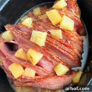 slow cooker ham with pineapple on top, ready to serve.