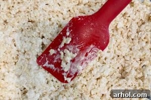Spread Rice Krispies mixture evenly into the prepared pan.