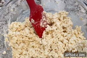 Mix Rice Krispies cereal into the marshmallow mixture until fully coated.