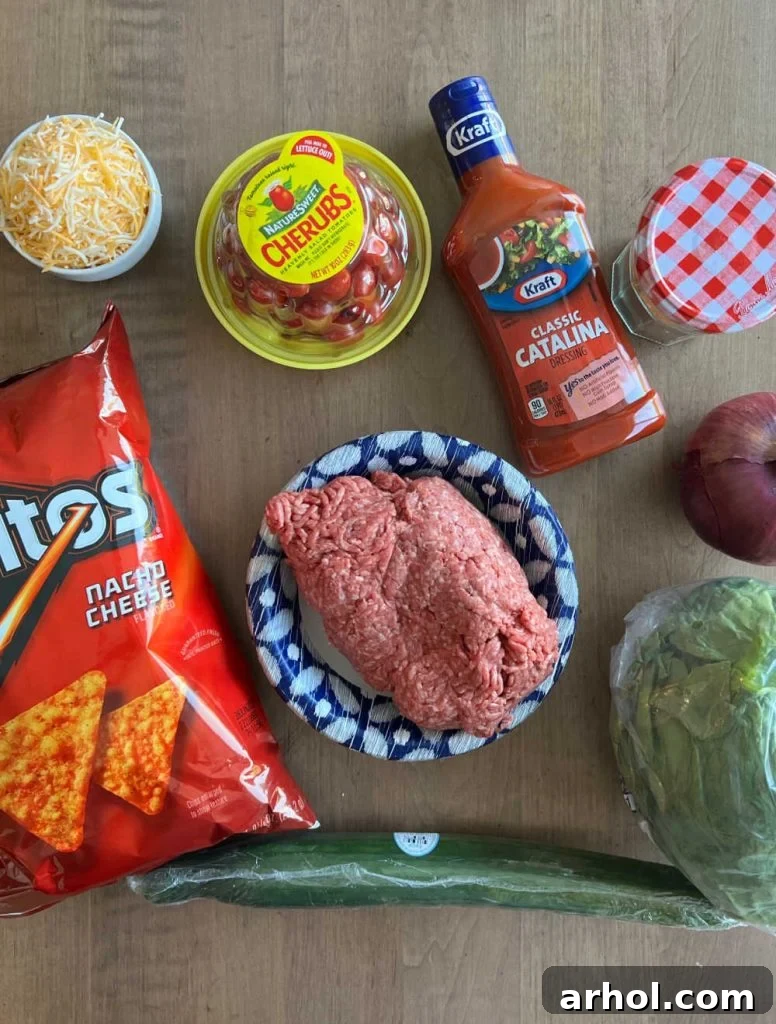 doritos, ground meat, catalina dressing, lettuce, cheese and salad ingredients