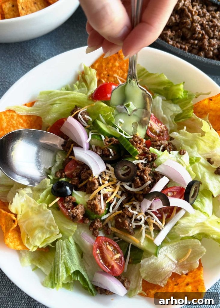 mix taco meat with doritos and salad