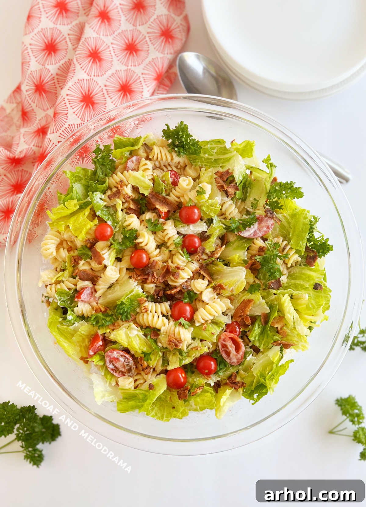 Perfect BLT Pasta Salad 2 BLT pasta salad with rotini, bacon, lettuce and tomatoes in a glass serving bowl, ready to be enjoyed as a perfect summer dish.