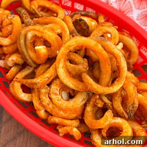 Crispy Arby's frozen curly fries in an air fryer, golden brown and ready to serve.