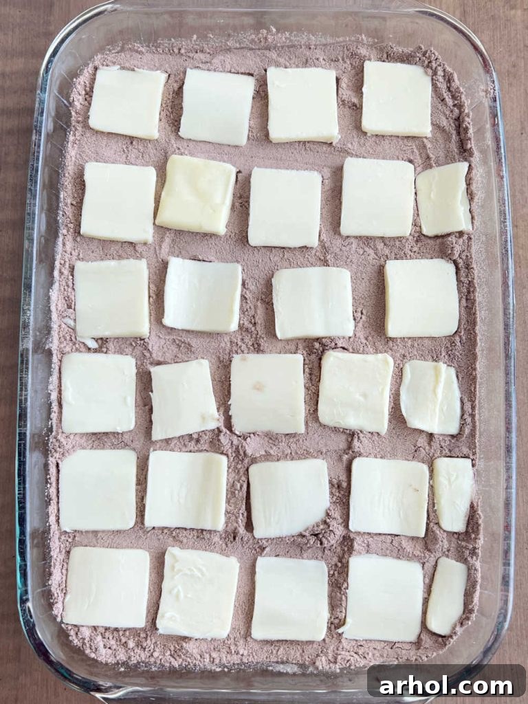 pats of butter on chocolate dump cake