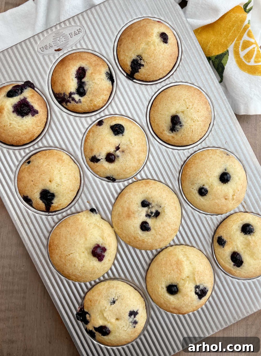 Warm Baked Cake Mix Blueberry Muffins A tray of freshly baked, golden-brown blueberry muffins, still warm in their muffin tin, just pulled from the oven