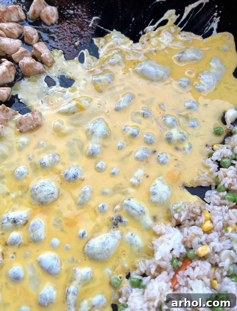 cooking eggs with chicken and rice on blackstone griddle