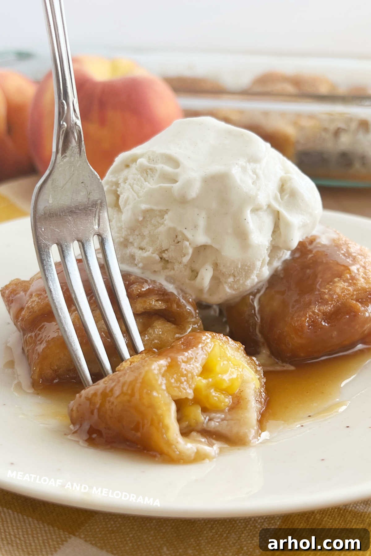 crescent roll peach dumplings and vanilla ice cream on fork