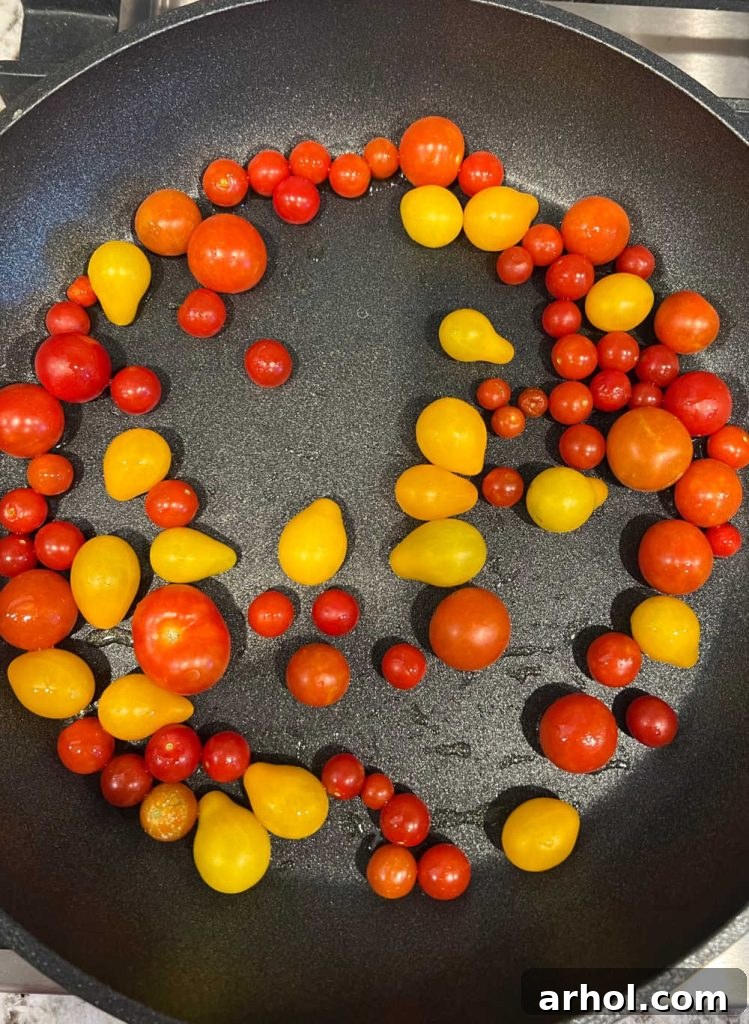cook fresh grape tomatoes and cherry tomatoes in skillet