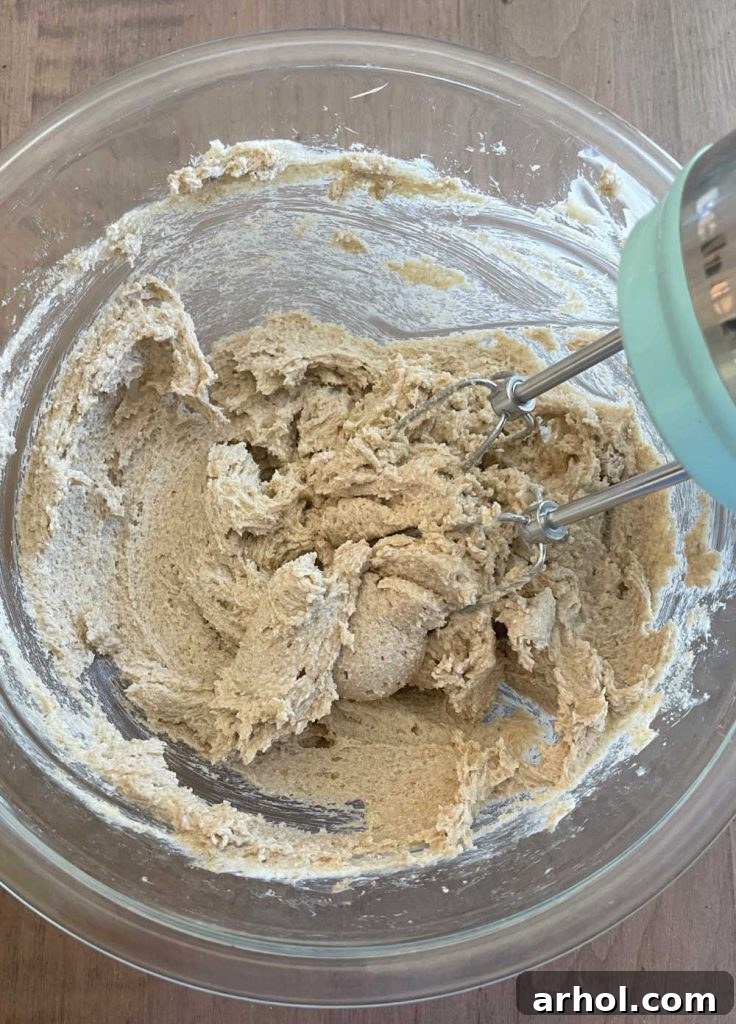 Creaming butter and sugars in a mixing bowl until light and fluffy.