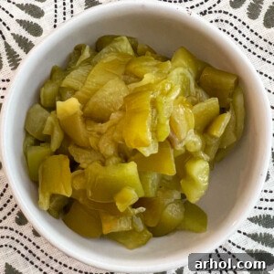 A small bowl containing homemade diced roast Hatch chiles, showcasing their vibrant green color and tender texture.