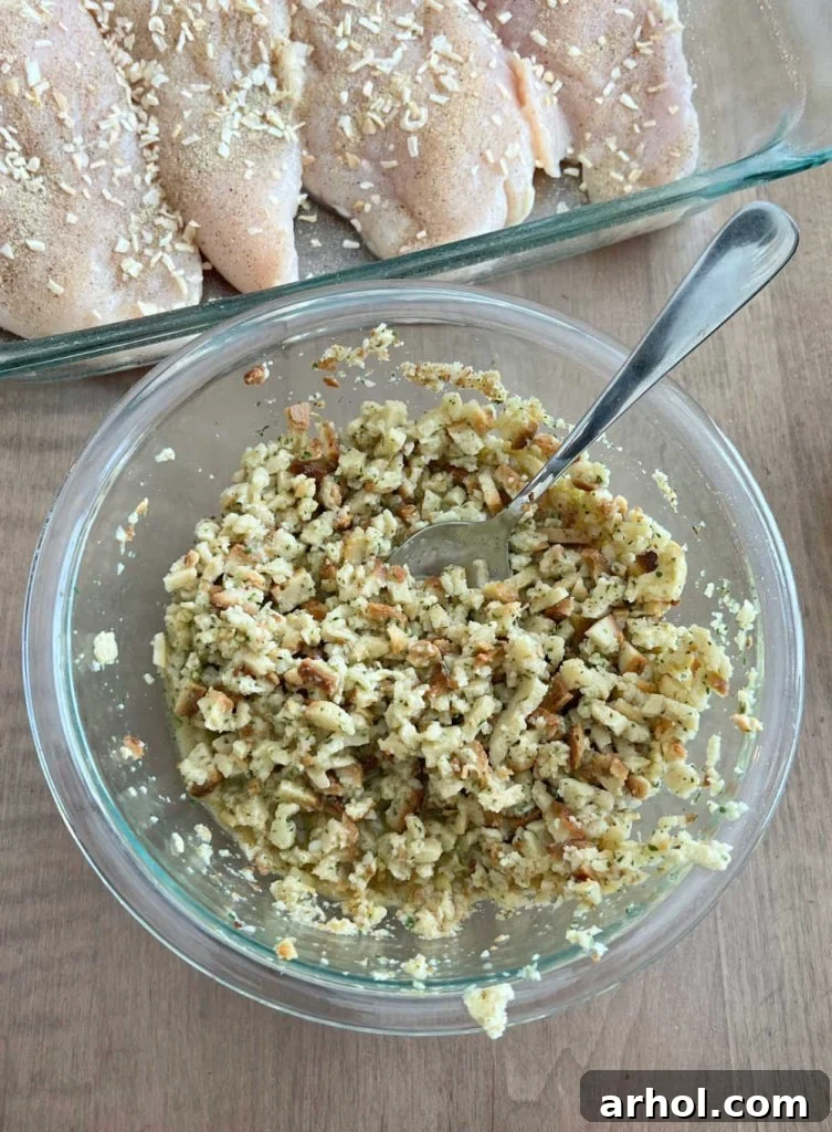 Dry stuffing mix ready to be combined with chicken broth, next to seasoned chicken breasts nestled in a greased casserole dish.