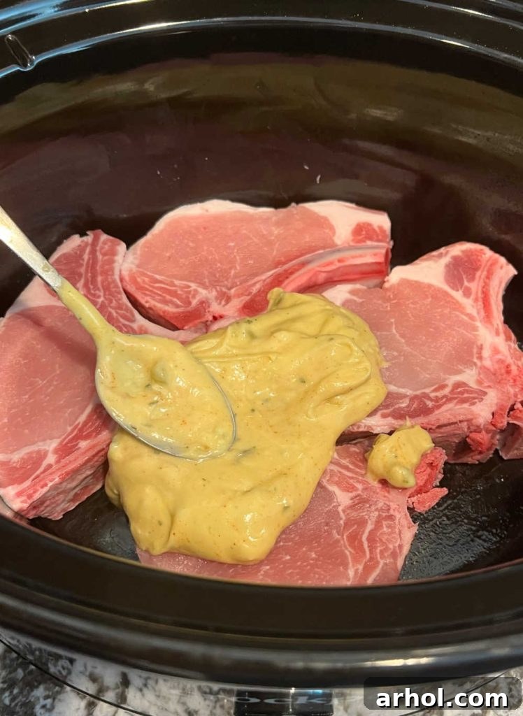 spread soup mixture over bone-in pork chops in slow cooker
