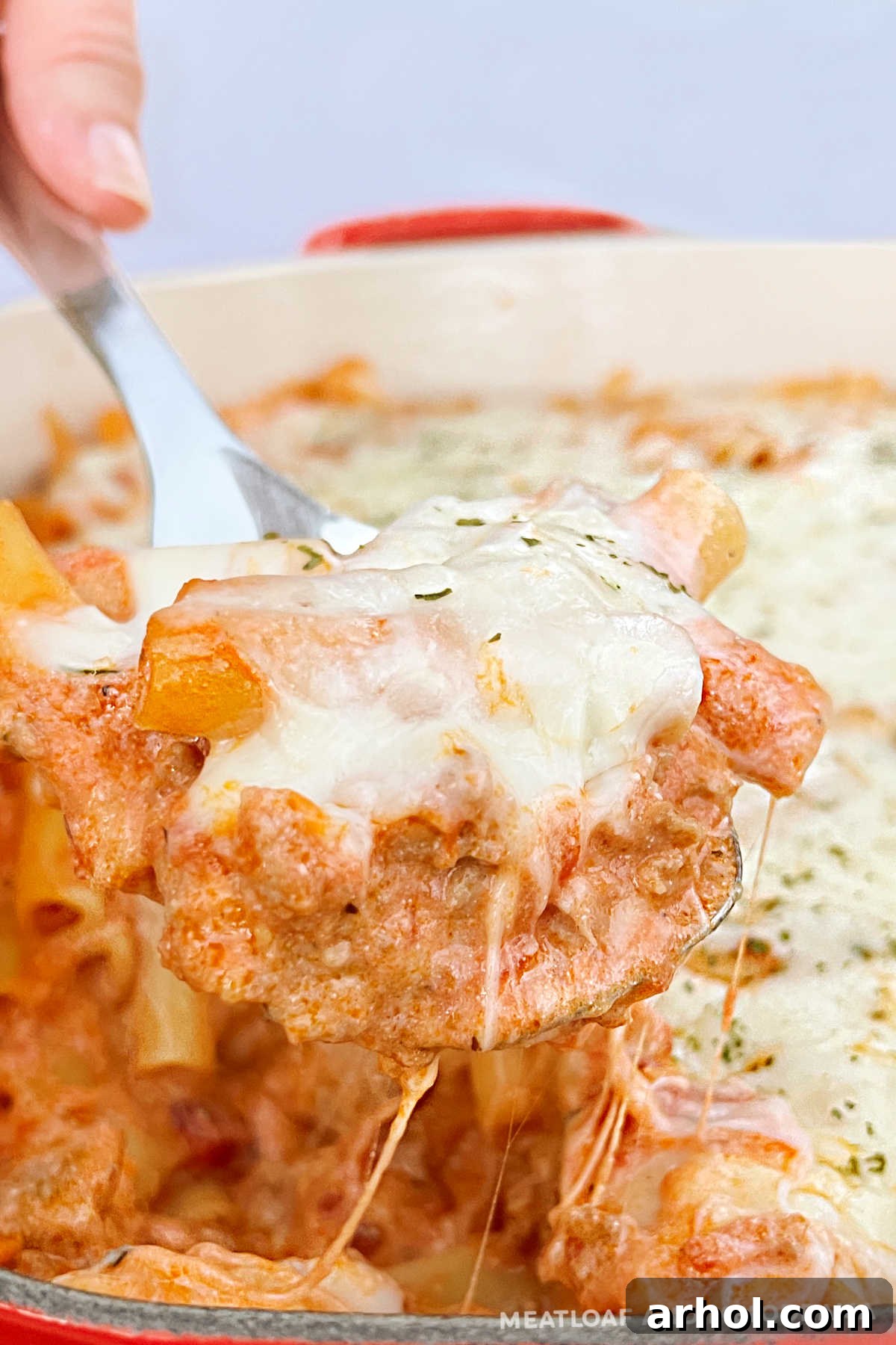 Delicious Instant Pot Baked Ziti with sausage, ricotta and mozzarella on a serving spoon