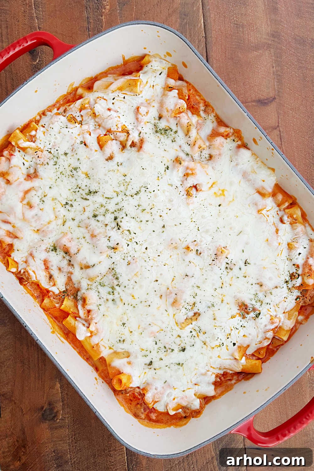 Baked ziti recipe with sausage in casserole dish, freshly out of the oven