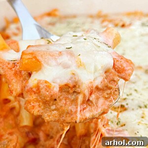 Instant Pot baked ziti with mozzarella cheese on serving spoon, ready to eat