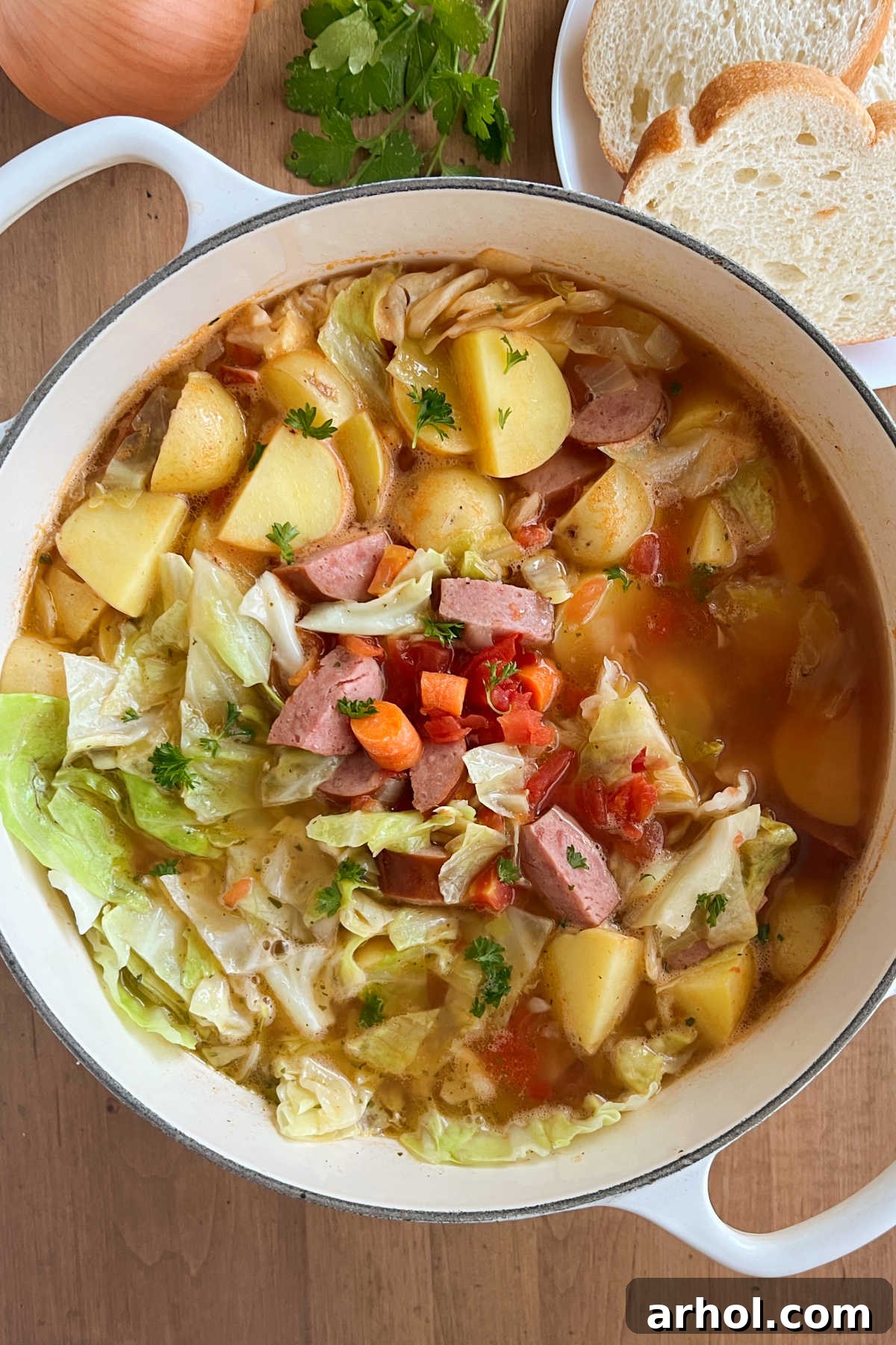 Hearty Cabbage Soup with Kielbasa Sausage, Carrots, and Potatoes in a Dutch Oven