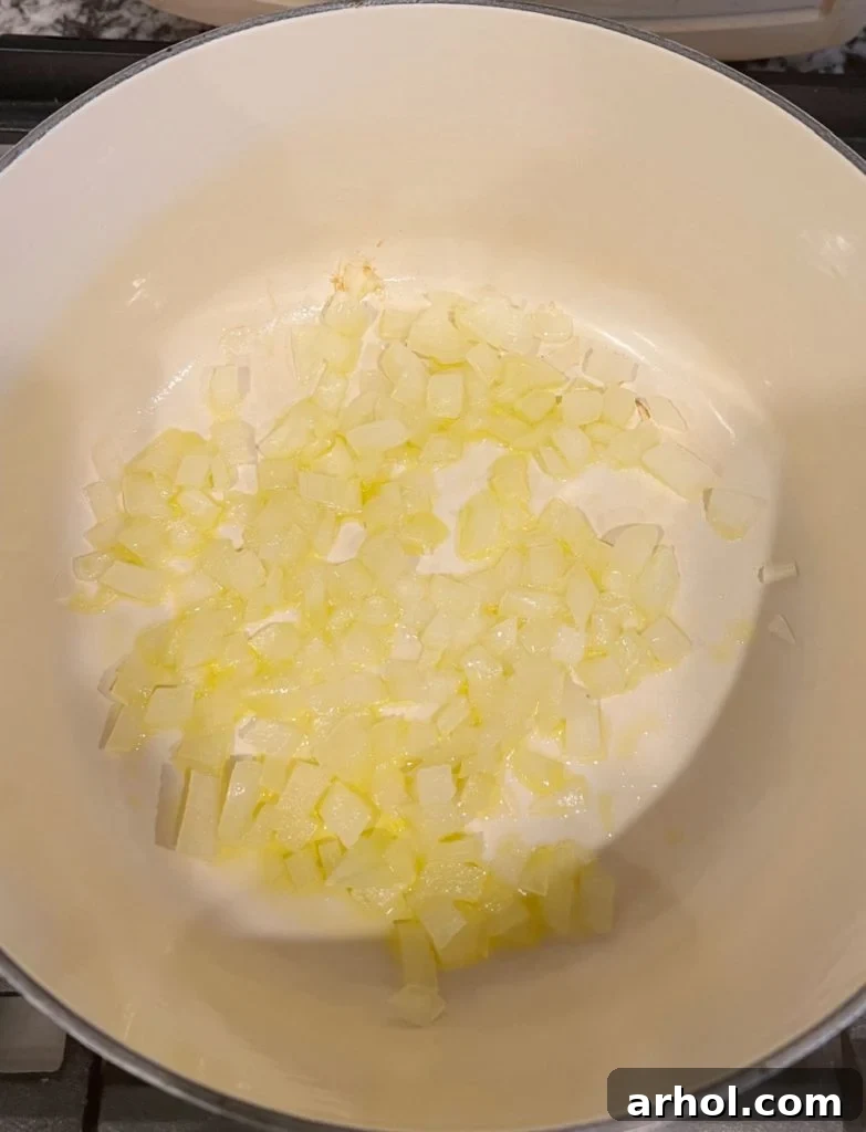 Sautéing diced onions in olive oil in a Dutch oven