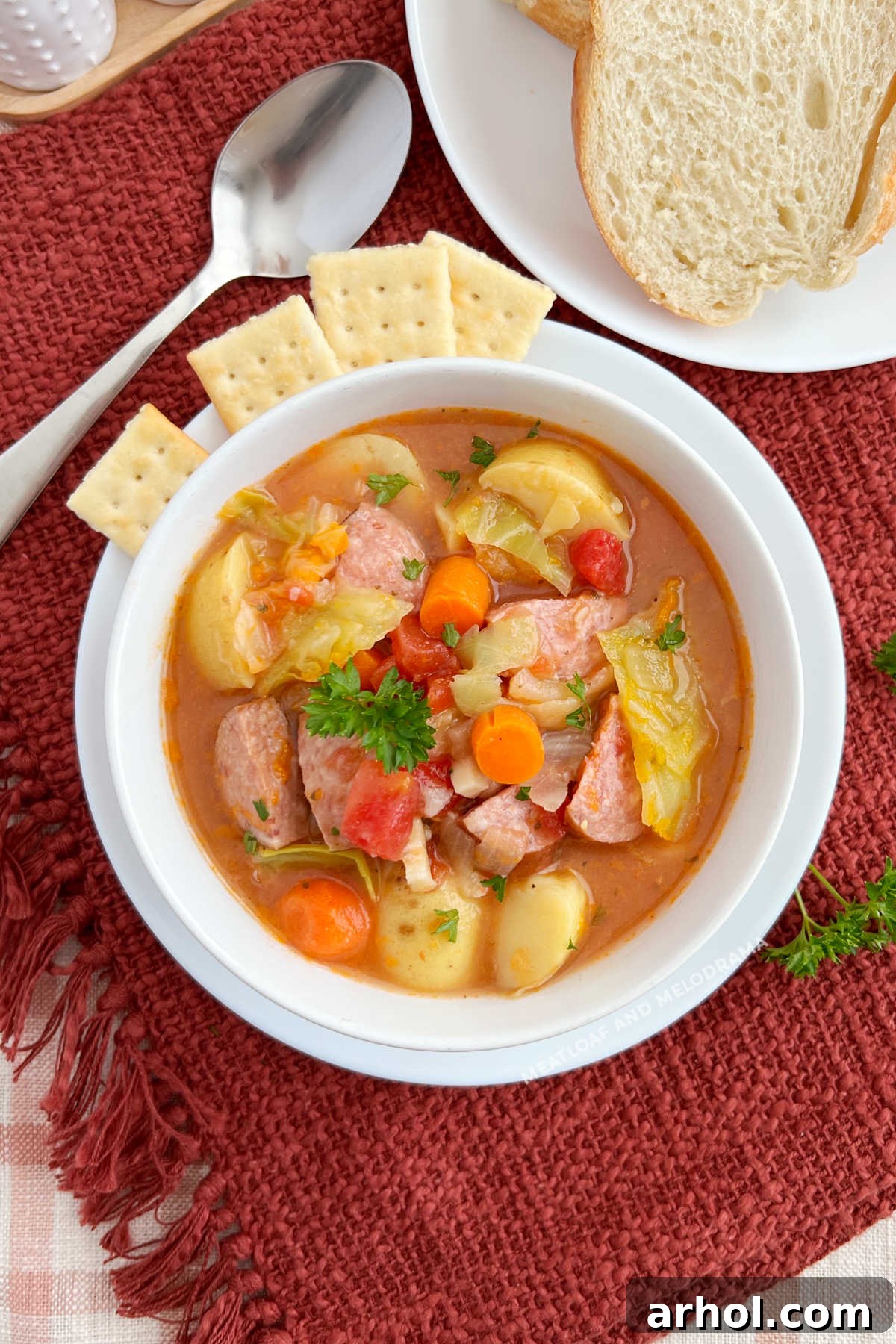 A comforting bowl of Cabbage Soup with Smoked Sausage and Potatoes on a table