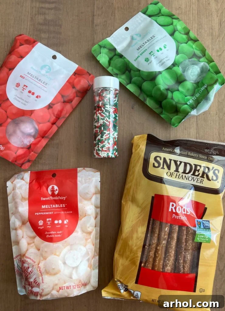 candy coating in red, white, and green, alongside holiday sprinkles and a bag of Snyder's pretzel rods