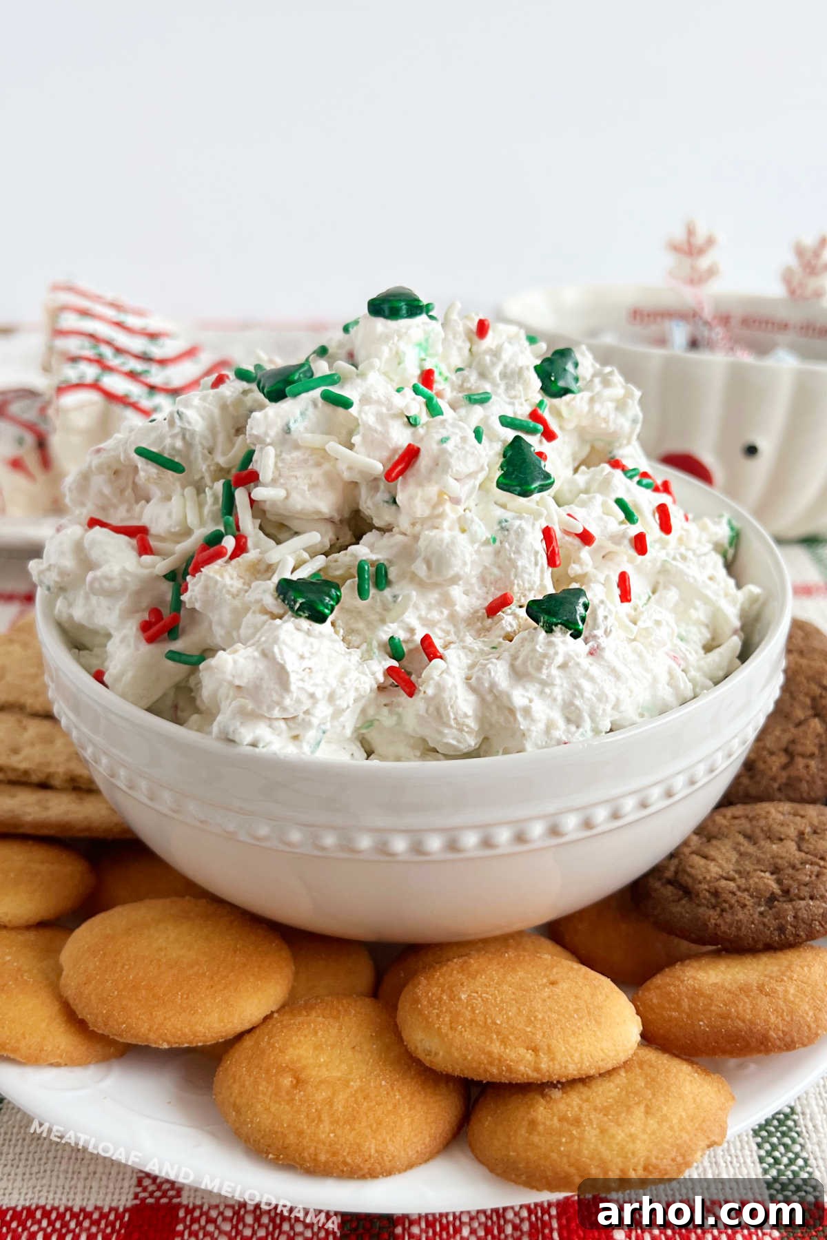 little Debbie Christmas tree cake dip with holiday sprinkles and dippers on a platter