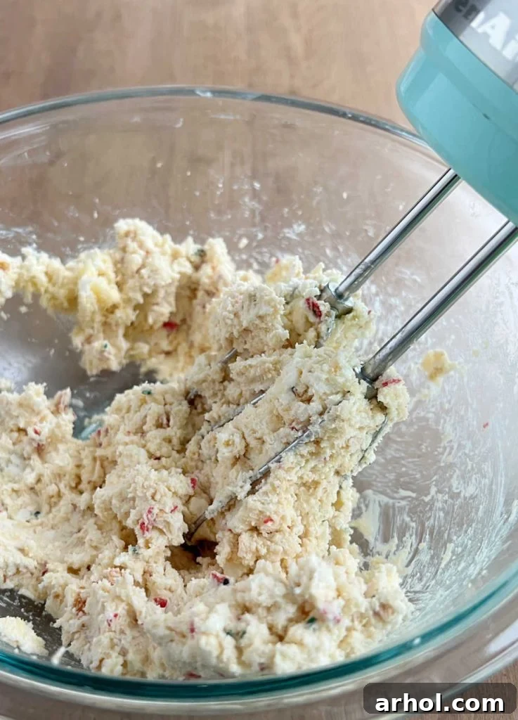 mix christmas tree cakes and cream cheese in mixing bowl with hand mixer