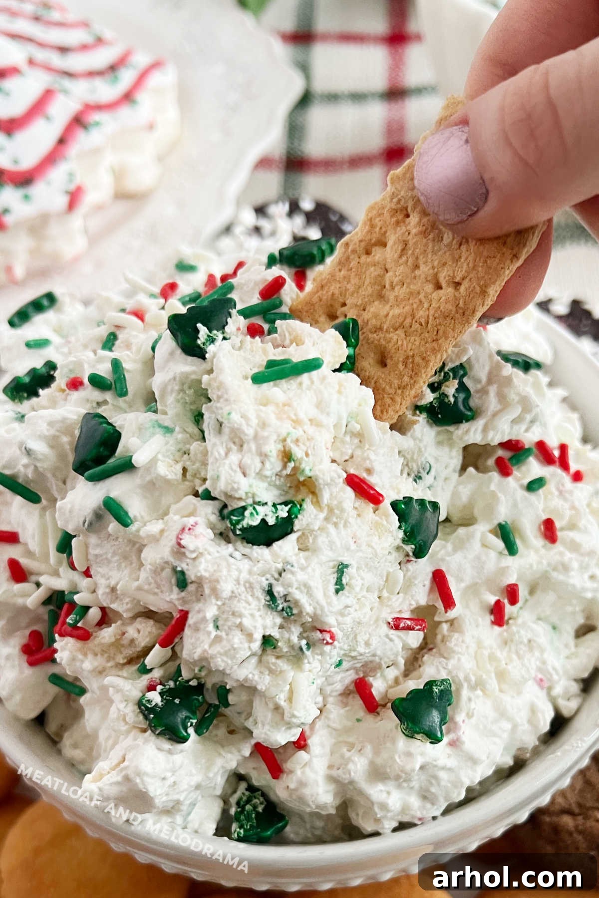 dip graham cracker into Christmas tree dip