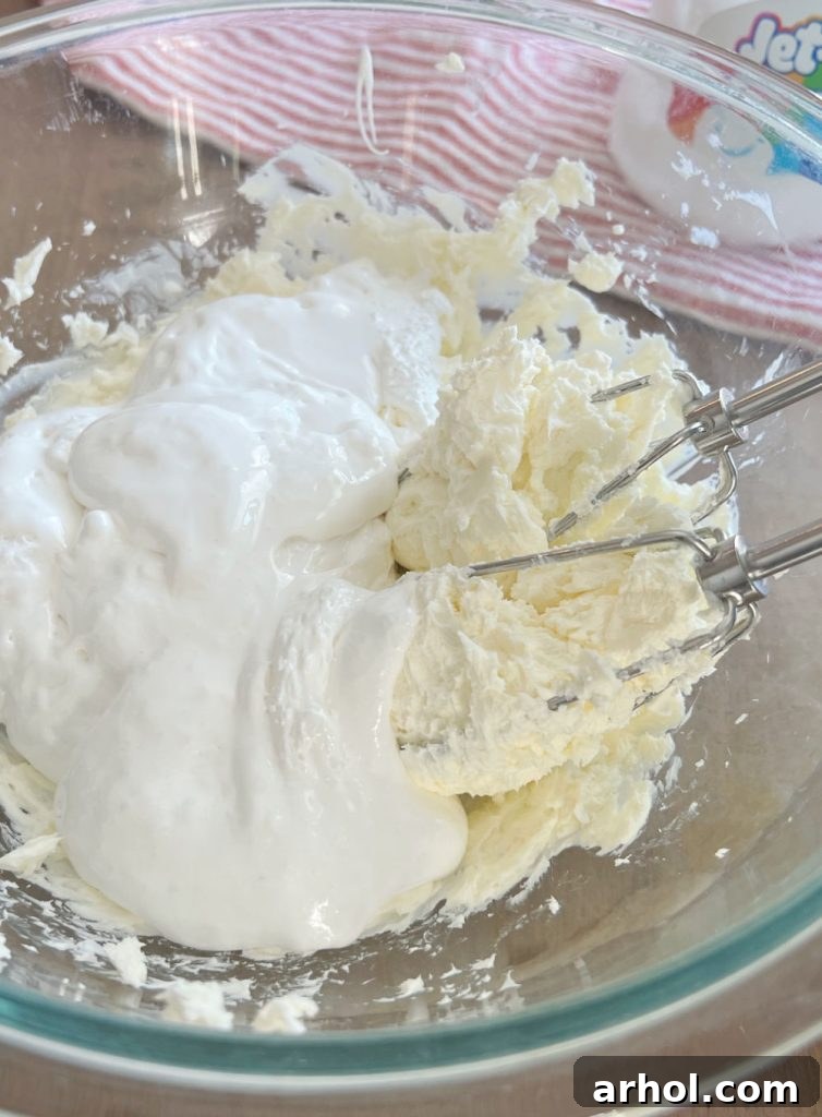 Luscious Cherry Cheesecake Dip 4 Beating softened cream cheese and marshmallow fluff together in a large bowl with a hand mixer.
