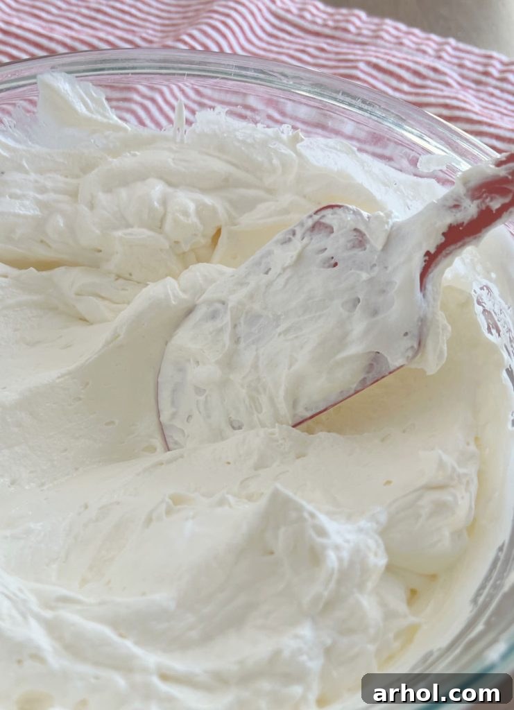 Luscious Cherry Cheesecake Dip 5 Gently folding in Cool Whip to the cream cheese and marshmallow mixture with a spatula.