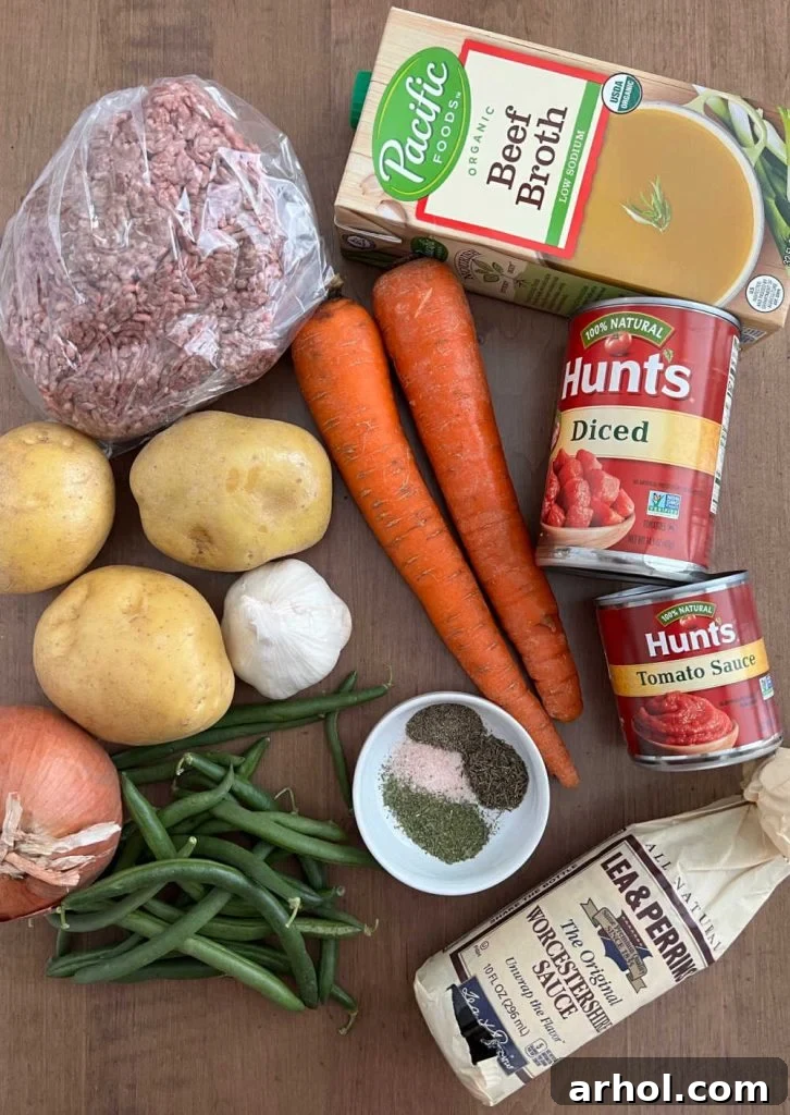 Comforting Ground Beef and Veggie Soup 3 Collection of fresh ingredients for ground beef vegetable soup including ground beef, beef broth, fresh vegetables, diced tomatoes, tomato sauce and seasonings.