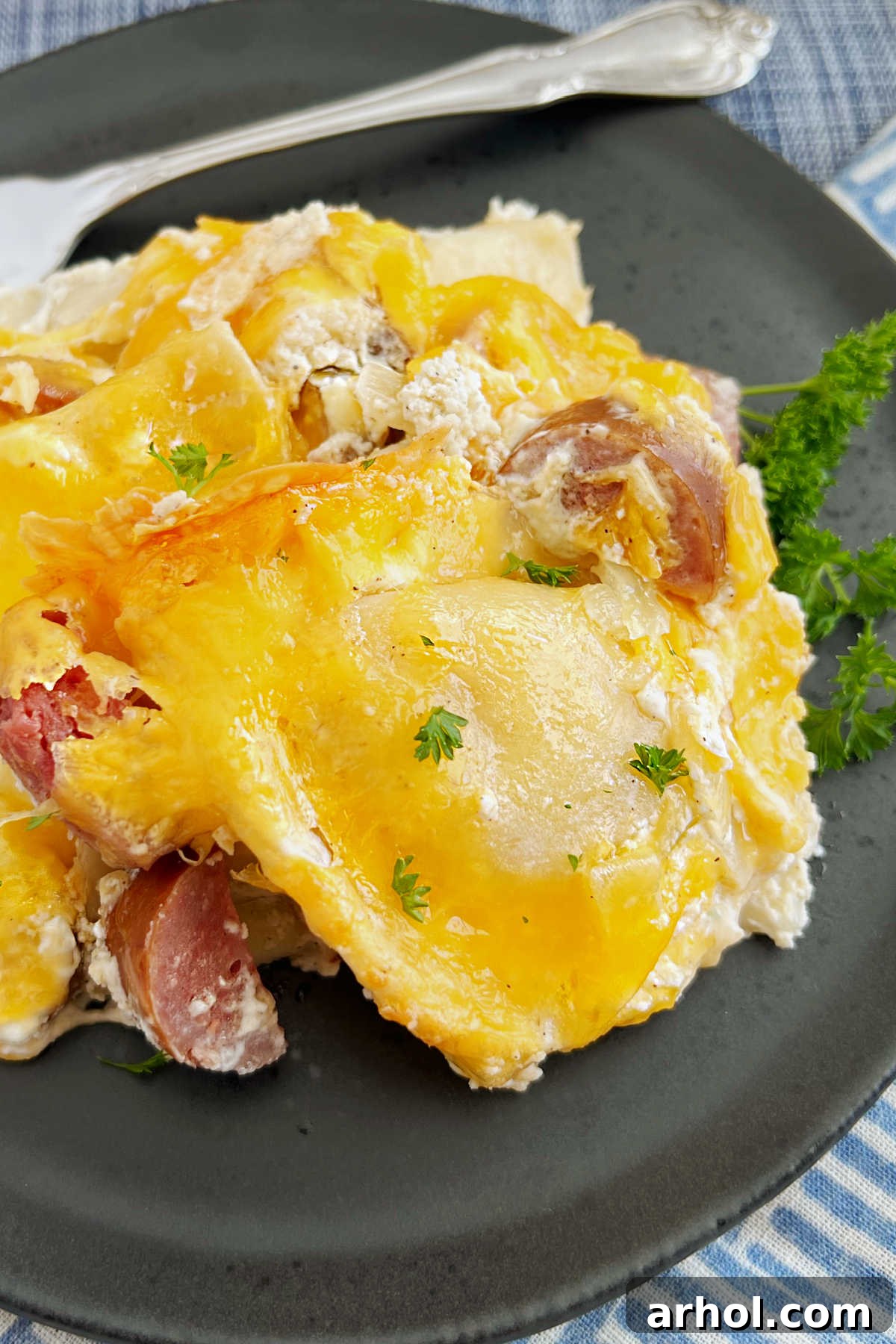 baked pierogi casserole with kielbasa sausage and cheese on a plate