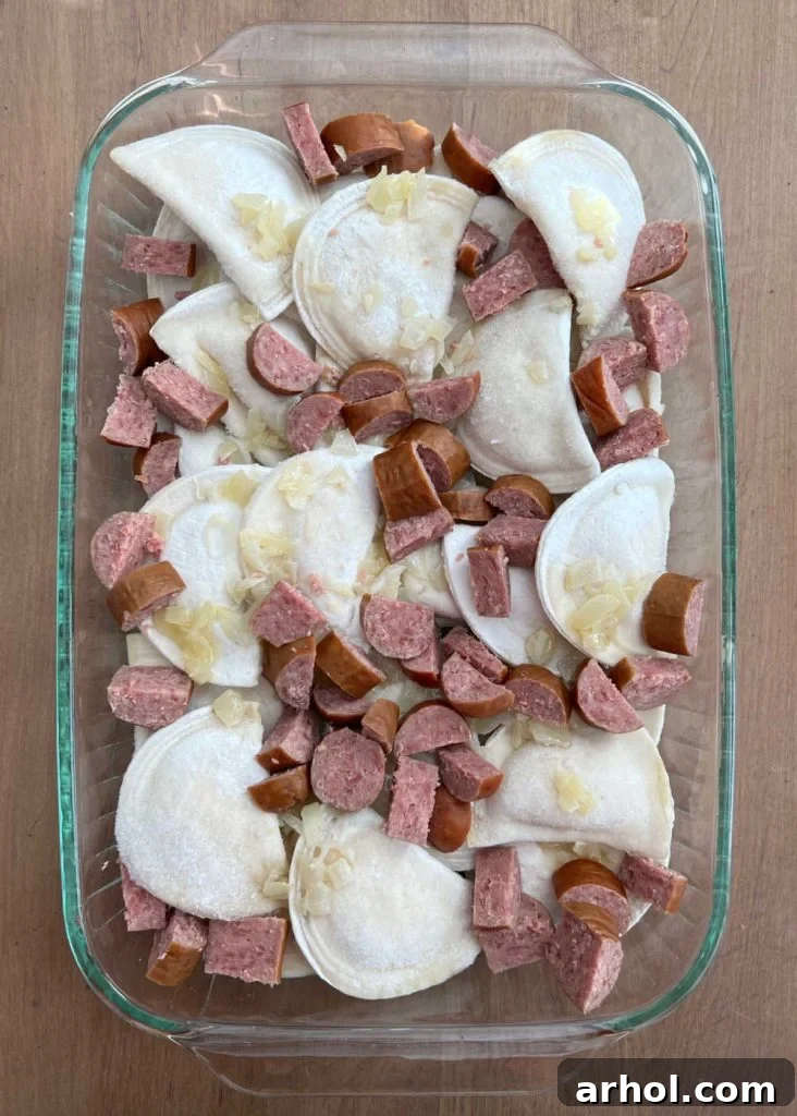 frozen pierogi with kielbasa slices and onions in casserole dish