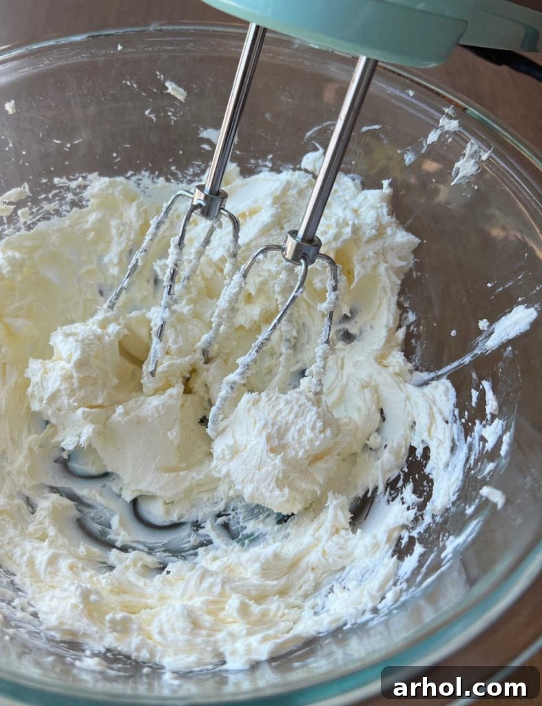 Blend cream cheese and sour cream in mixing bowl with electric mixer until smooth