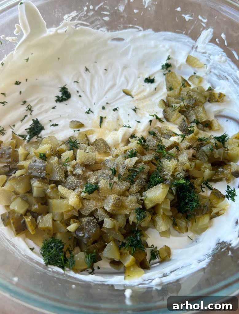 Mix chopped pickles, pickle juice, and seasonings into the cream cheese mixture