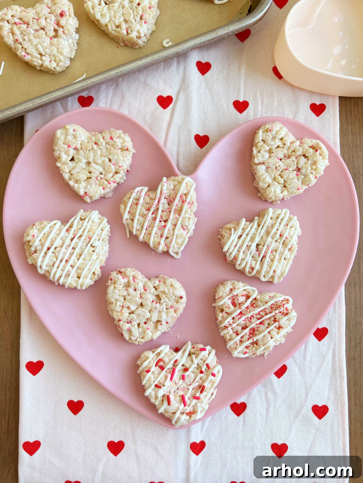 Heart-shaped Rice Krispies treat cut-outs on a pink heart plate, ready for Valentine's Day