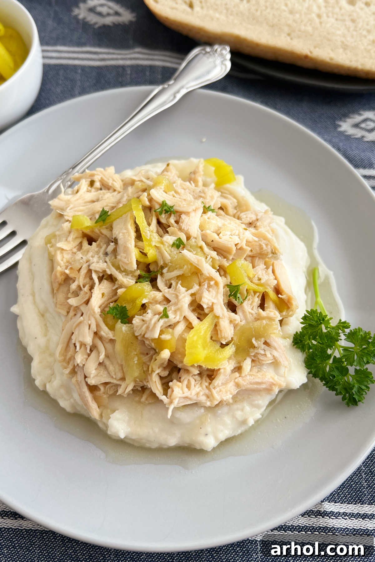 Effortless Mississippi Pot Roast Chicken 2 Crock Pot Mississippi Chicken with pepperoncini peppers served over creamy mashed potatoes on a plate