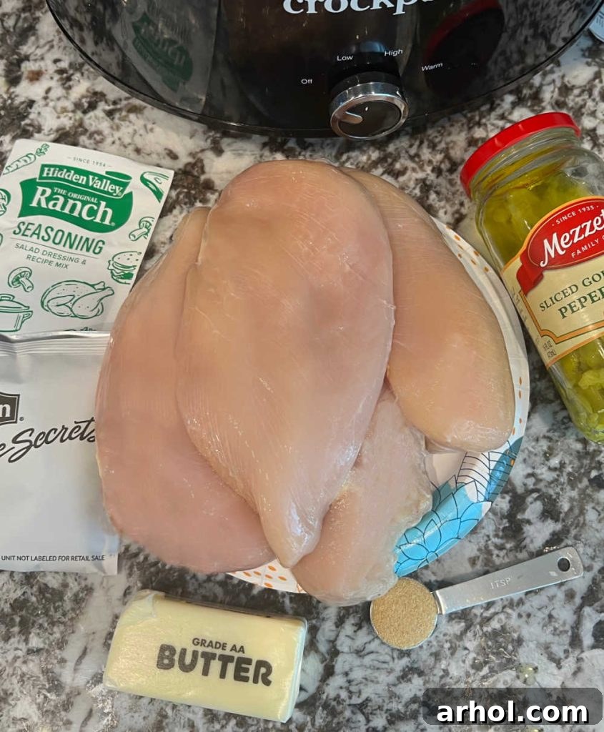 Effortless Mississippi Pot Roast Chicken 4 Ingredients for Mississippi chicken: chicken, ranch seasoning, onion soup mix, garlic powder, butter, and pepperoncini peppers.