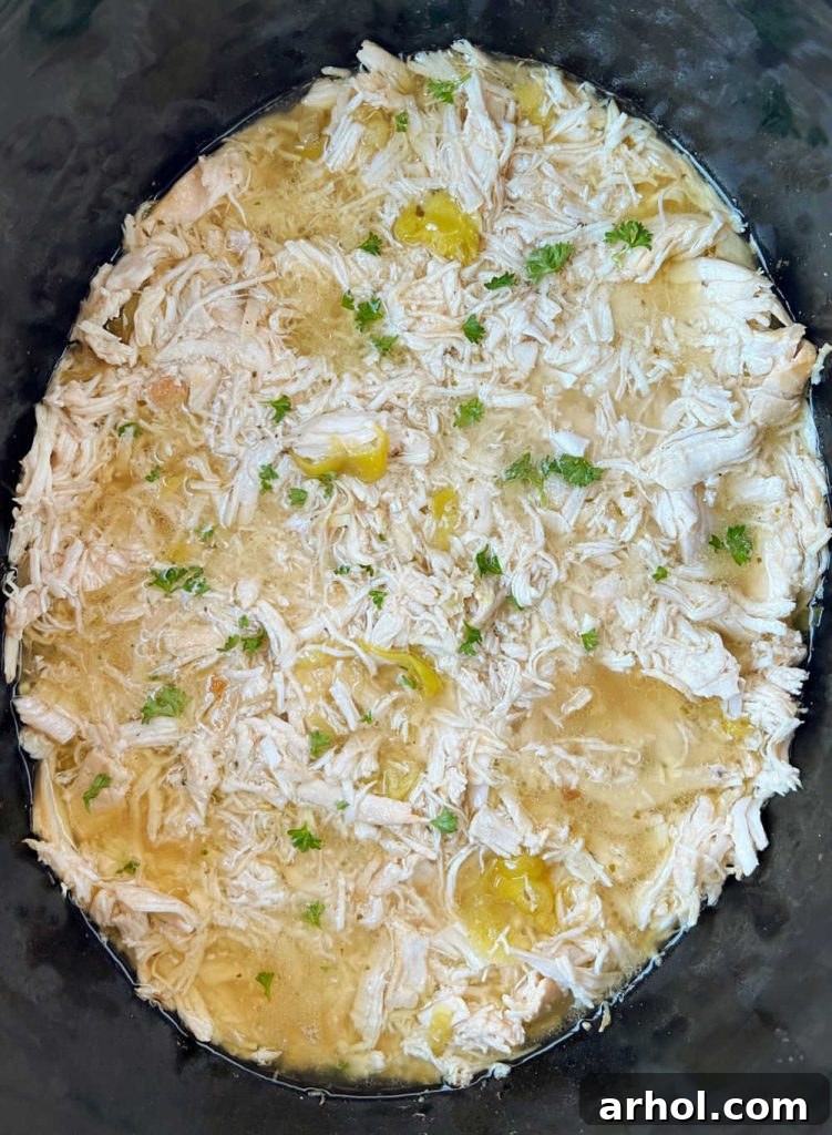 Effortless Mississippi Pot Roast Chicken 7 Shredded Mississippi chicken soaking in juices within the slow cooker.