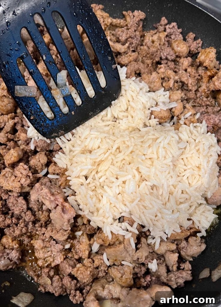 Cook ground beef and sausage with white rice in skillet
