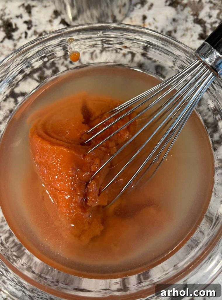 Mix tomato soup with beef broth or water in mixing bowl