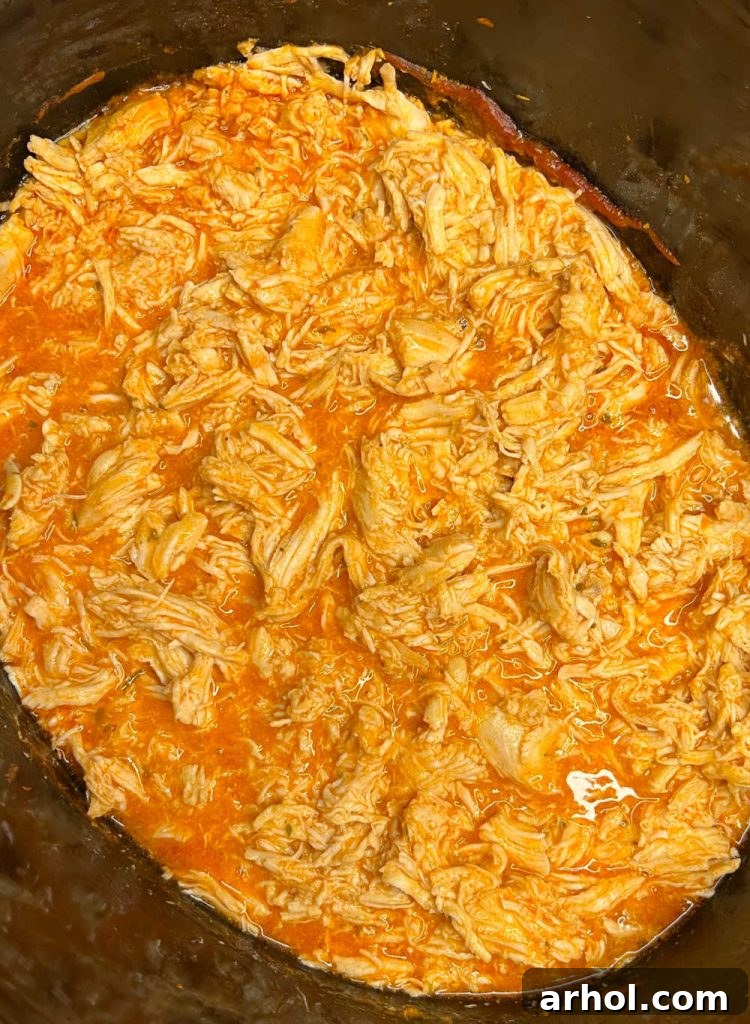 shredded buffalo chicken in slow cooker, ready to serve