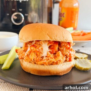 crock pot buffalo chicken sandwiches with ranch dressing and celery sticks