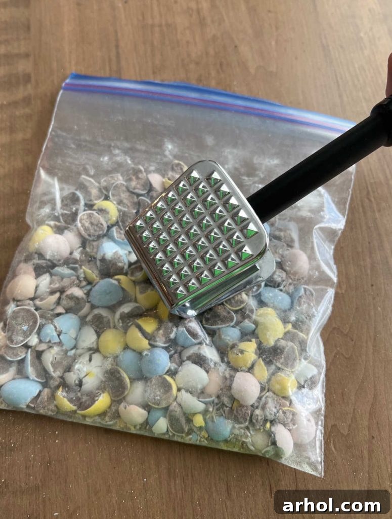 Crush mini egg candy with a mallet inside a bag