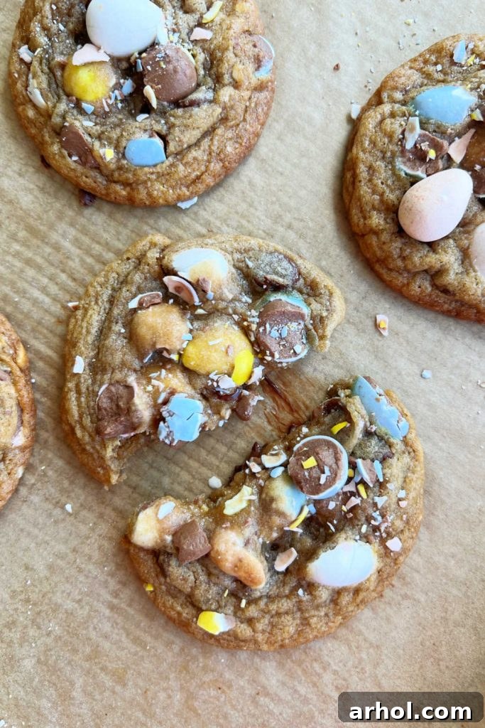 Cadbury mini eggs cookie cut in half, revealing the chocolate chips and mini egg chunks inside