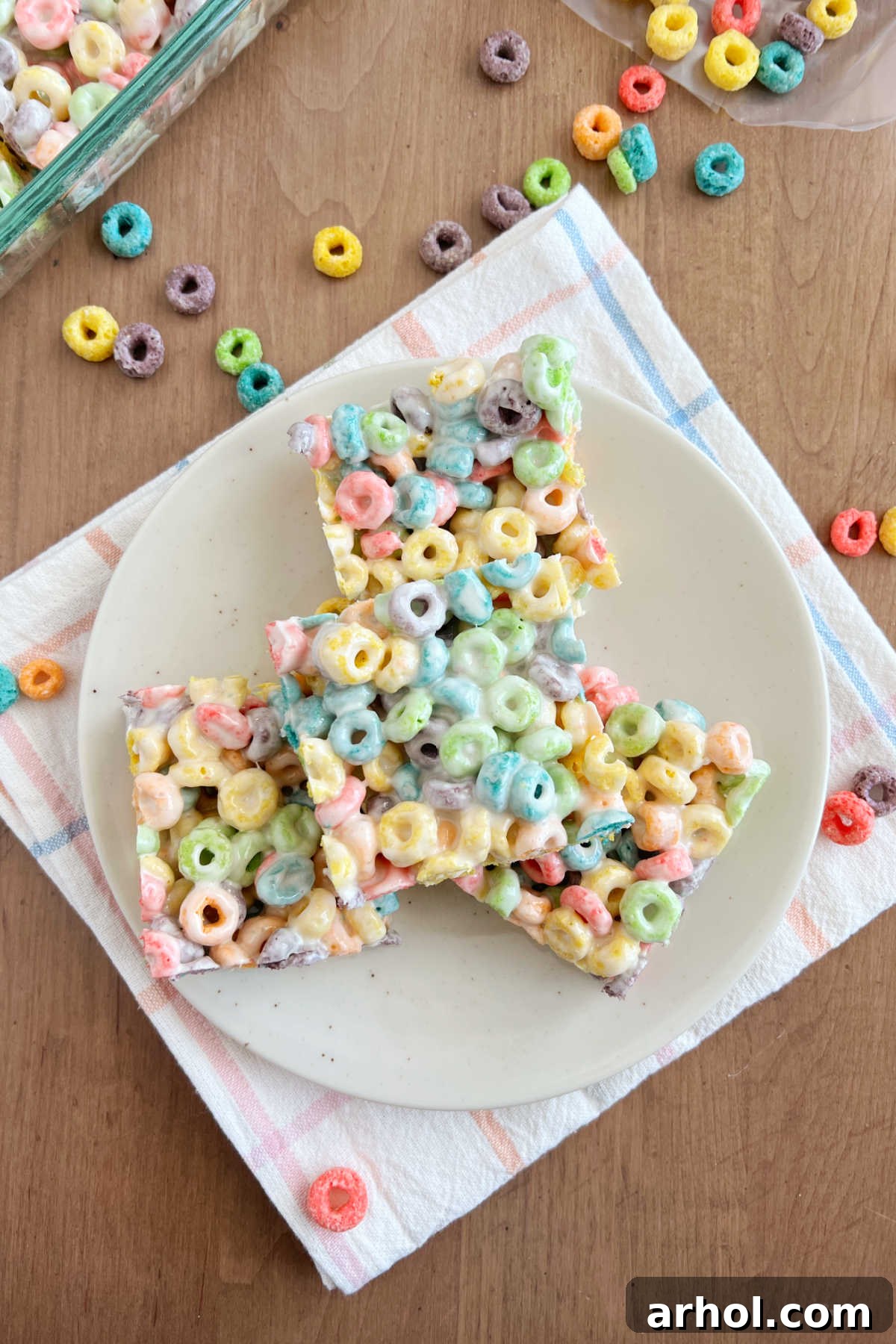 A plate of colorful Froot Loop Bars, showcasing their vibrant appearance and chewy texture, made with Froot Loops cereal and gooey marshmallows.